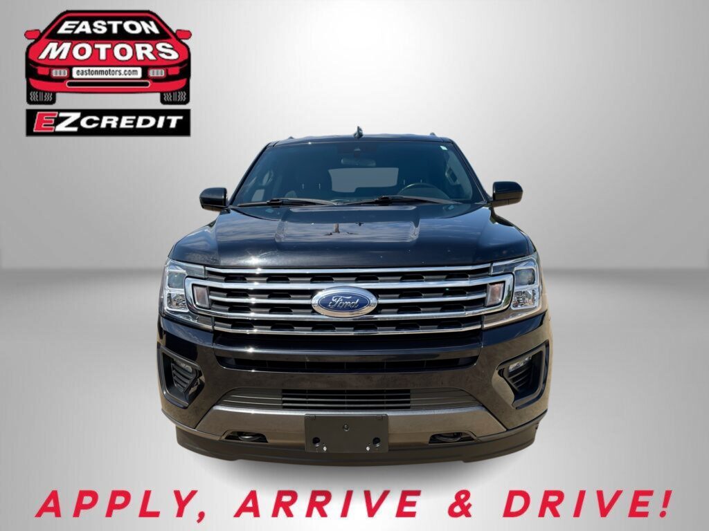 Front view of a dark blue Ford SUV against a gray backdrop with an Easton Motors EZ Credit logo on the left and red 'APPLY, ARRIVE & DRIVE!' text below.