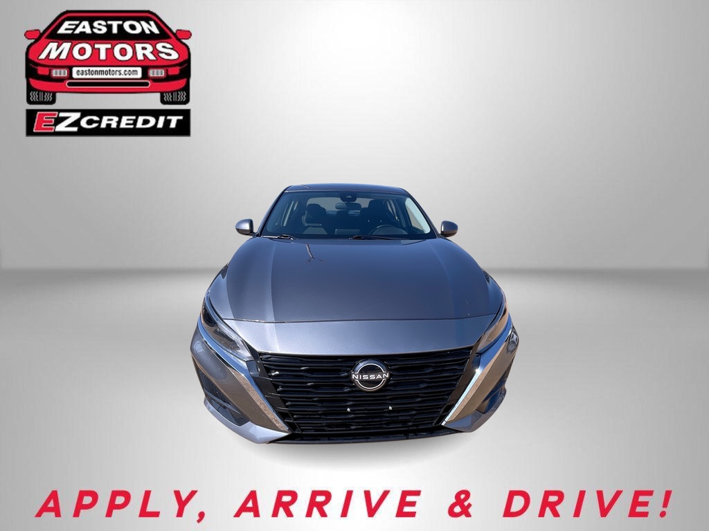 Front view of a silver Nissan sedan in an Easton Motors ad with EZCredit logo and the slogan 'APPLY, ARRIVE & DRIVE!'