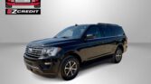 Black SUV on a gray backdrop with Easton Motors EZCredit logo in the top left and 'APPLY, ARRIVE & DRIVE!' text at the bottom.