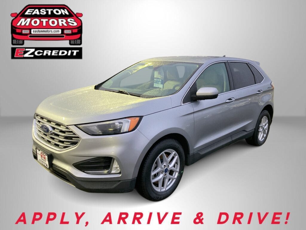 Silver Ford SUV in a showroom with Easton Motors logo on the wall; dealership slogan 'Apply, Arrive & Drive!' visible.