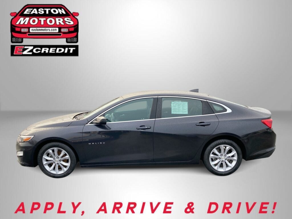 Dark gray sedan photographed from the side with an Easton Motors EZCredit logo in the upper left and the slogan “APPLY, ARRIVE & DRIVE!” in red at the bottom sugar-gray background.