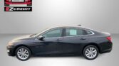 Dark gray sedan photographed from the side with an Easton Motors EZCredit logo in the upper left and the slogan “APPLY, ARRIVE & DRIVE!” in red at the bottom sugar-gray background.
