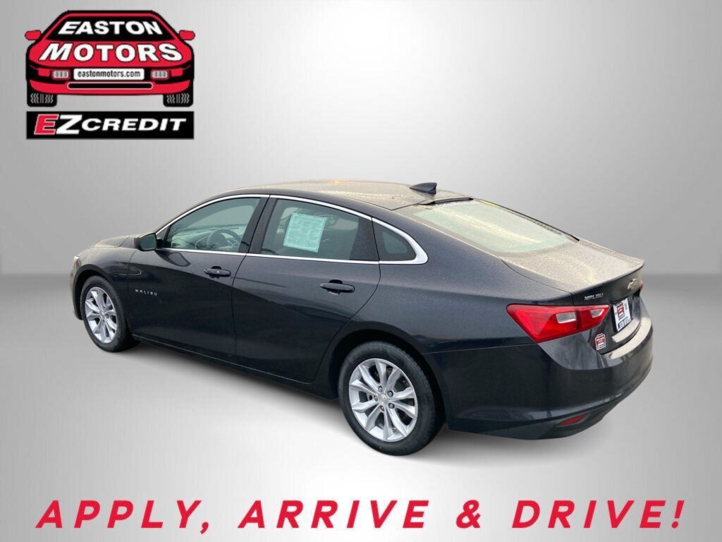 Black Chevrolet Malibu rear three-quarter view with Easton Motors EZCredit logo in the upper left and the slogan 'APPLY, ARRIVE & DRIVE!' at the bottom.