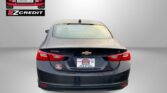 Rear view of a black Chevrolet Malibu with EZCredit logo on the left and dealership plates, rain on the car window, and a bold 'APPLY, ARRIVE & DRIVE!' phrase at the bottom.