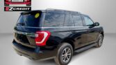 Black Ford Expedition SUV with EZ Credit and Easton Motors logos, parked against a gray backdrop.