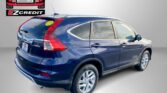 Blue Honda SUV takes up the foreground against a gray backdrop, with an EZ Credit logo on the left and red text reading 'APPLY, ARRIVE & DRIVE!' at the bottom.