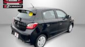 Dark hatchback car with rain droplets parked indoors; Easton Motors logo on the wall and a large 'EZCredit' sign beside it. Text reads 'APPLY, ARRIVE & DRIVE!' at the bottom.