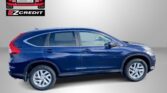 Blue SUV in a showroom-style setting with Easton Motors EZ Credit logo top-left and the slogan 'APPLY, ARRIVE & DRIVE!' in red text at the bottom.