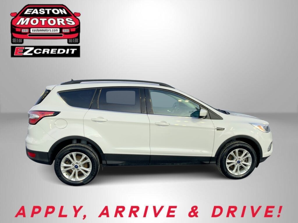 White SUV shown from the side with Easton Motors logo and EZCredit branding in the top-left; ad text at bottom reads 'APPLY, ARRIVE & DRIVE!'