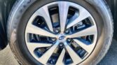 Close-up of a tire mounted on a silver and black alloy wheel with a Subaru badge at the center.