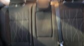 Rear seats of a car with a folded center armrest and visible seat belts