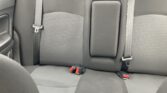 Rear car bench seat with three seating positions, features a center armrest and visible outer seat belts/buckles at sides.