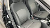 Interior view of a car showing the front seats with black patterned upholstery and center console with gear selector visible