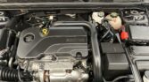 Under-hood view of a modern car engine with an ECOTEC cover, coolant reservoir, and battery visible on the right side.