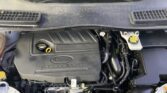 Front half of a car engine bay with a Ford 1.5L EcoBoost engine cover visible under the hood