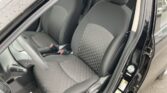 Front passenger and driver seats in a car with gray patterned upholstery and black surrounds, visible seat belts, and center console at the door sill level