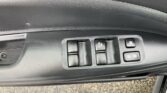 Car door control panel with window switches and a lock button inside a vehicle door