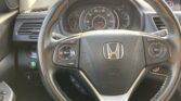 Close-up of a car steering wheel with a digital dashboard showing speedometer and tachometer, cruise control buttons on the right, and an Eco mode indicator on the left.