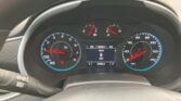 Car dashboard viewed from the driver’s seat showing tachometer, speedometer, fuel and engine temperature gauges and a central digital display