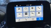 In-car touchscreen showing app icons (Sound, Clock, Bluetooth, Phone, Radio, Mobile Apps) with Settings tile highlighted in blue at bottom right, time 4:14 outside temperature 30° outside.