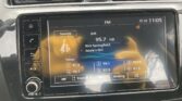 Car dashboard touchscreen showing FM radio, 95.7 HD, 'Rick Springfield – Jessies Girl' with preset stations 87.9, 98.1, 107.9 and time 11:05 (HD icon visible).