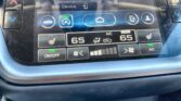 Car infotainment screen showing 'Add Device' option with home icon and climate controls at 65°F.