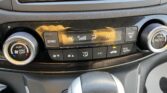 Center console climate control panel with two large knobs on sides (left: Push On/Off, right: Push Auto) and a digital display showing 'Hi' with fan and airflow icons; SYNC, A/C, and defog buttons visible on a glossy black surface.