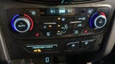 Car climate control panel: dual temperature dials (blue/red) with Auto on left and A/C on right, multiple buttons below for defrost and vents.