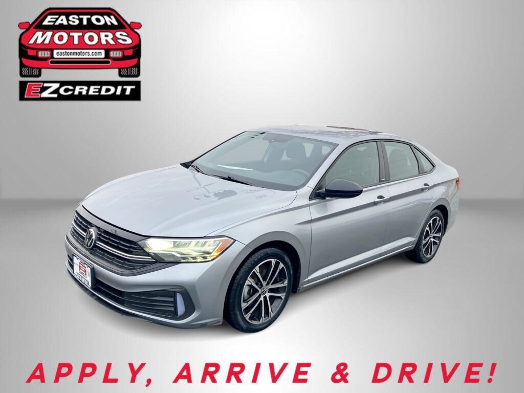 EZ Credit logo above a white Volkswagen sedan on a gray background; bottom text reads 'APPLY, ARRIVE & DRIVE!'