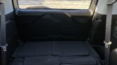 Car cargo area with folded floor mats and rear window visible in the back of the vehicle