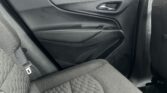 Rear passenger door interior: black panel, chrome door handle, window switch, and quilted dark fabric seats with contrast stitching