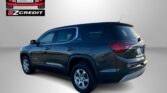 Rear view of a dark blue GMC Acadia with EZCredit logo in the top-left corner and the slogan 'APPLY, ARRIVE & DRIVE!' at the bottom.