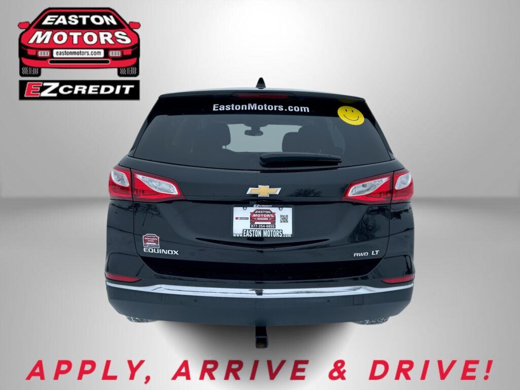Rear view of a black Chevy SUV with Easton Motors EZ Credit decals on the left wall, a yellow smiley sticker on the rear window, and the slogan 'APPLY, ARRIVE & DRIVE!' at the bottom.