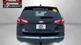 Rear view of a black Chevy SUV with Easton Motors EZ Credit decals on the left wall, a yellow smiley sticker on the rear window, and the slogan 'APPLY, ARRIVE & DRIVE!' at the bottom.