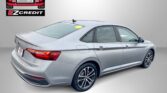 Silver sedan shown from the rear side next to an Easton Motors EZ Credit logo on a gray backdrop, with the banner text 'APPLY, ARRIVE & DRIVE!' in red at bottom.
