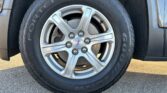 Close-up of a GMC alloy wheel with a Goodyear Fortera HC tire, showing the rim and brake disc behind it