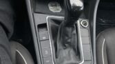 Close-up of a car's center console showing the automatic gear shifter with P R N D S, and surrounding control buttons like ECO and parking brake