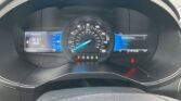 Center dashboard with a large speedometer, gear indicator (P R N D S) below, and left/right screens showing Seatbelts and Entertainment options respectively.