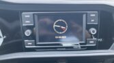 Infotainment screen with an analog clock and the date 12-18-2025, surrounded by Radio, Media, Phone, App, Menu, and Voice buttons in a car dashboard.