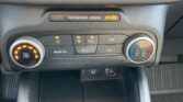 Car dashboard center: passenger airbag OFF indicator above climate controls and buttons below it.