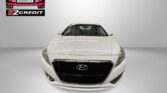 Front view of a white Hyundai car in a showroom with Easton Motors EZCredit logo and 'APPLY, ARRIVE & DRIVE!' text below.
