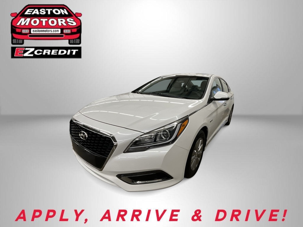 White sedan showcased at a dealership with Easton Motors EZCredit logos and the slogan 'APPLY, ARRIVE & DRIVE!' in red text at the bottom.