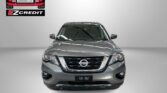 Front view of a gray Nissan SUV in a showroom with Easton Motors logo on the wall and 'APPLY, ARRIVE & DRIVE!' slogan underneath