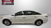White four-door sedan shown in a showroom with Easton Motors EZ Credit logos and the 'APPLY, ARRIVE & DRIVE!' slogan.