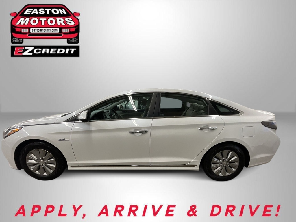 White four-door sedan shown in a showroom with Easton Motors EZ Credit logos and the 'APPLY, ARRIVE & DRIVE!' slogan.