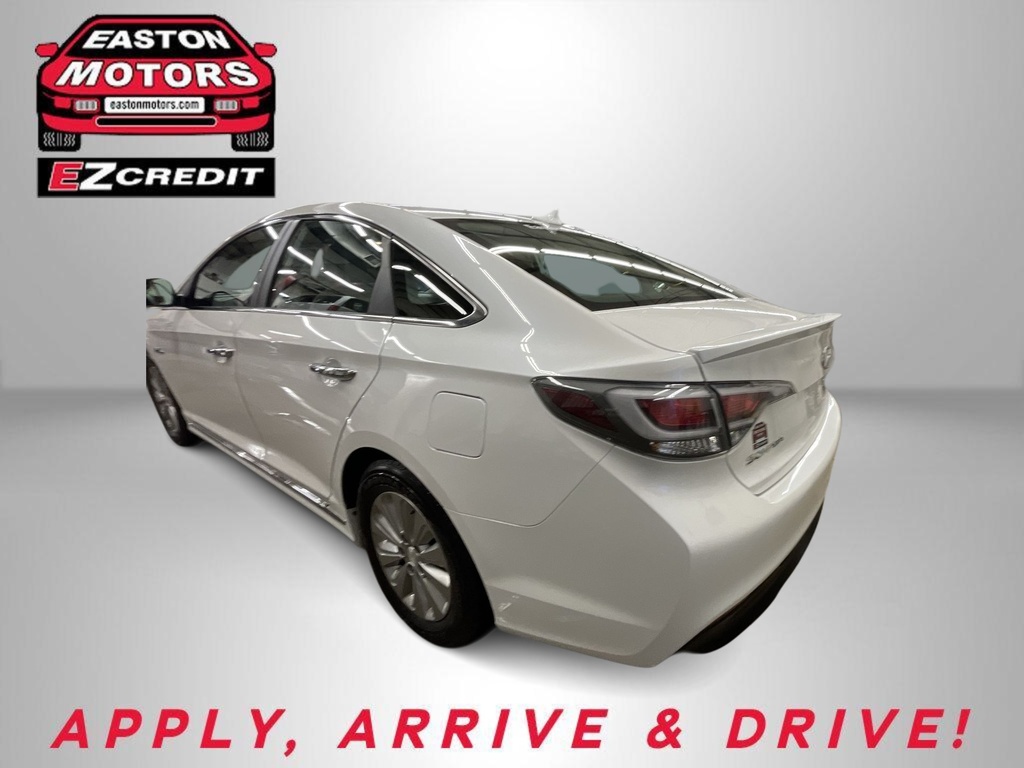 Rear three-quarter view of a white sedan with Easton Motors EZ Credit logo in the corner and 'APPLY, ARRIVE & DRIVE!' text at the bottom.