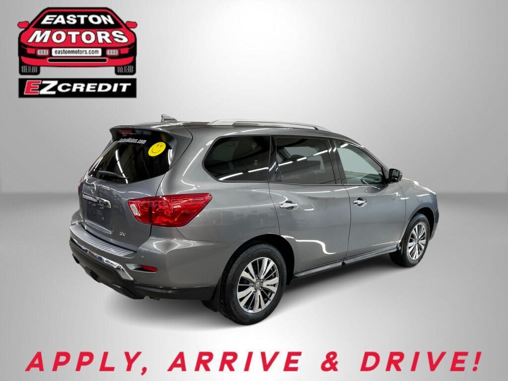 Grey SUV displayed in a showroom with an EZCredit logo on the wall; ad promoting easy car financing.