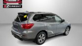 Grey SUV displayed in a showroom with an EZCredit logo on the wall; ad promoting easy car financing.