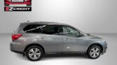 Gray SUV displayed in a showroom with Easton Motors EZ Credit logo and 'APPLY, ARRIVE & DRIVE!' banner at the bottom.