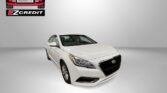 White Hyundai sedan displayed in a bright studio setting, Easton Motors EZCredit logo top left and 'APPLY, ARRIVE & DRIVE!' at the bottom.